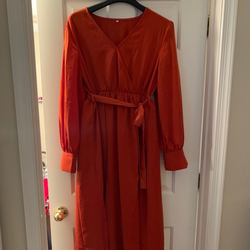 Women’s long rust colored dress.